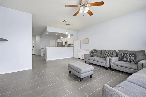 a living room with furniture and a chandelier