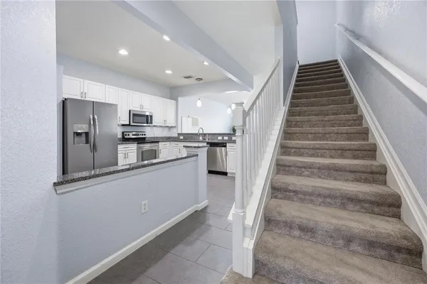 a view of kitchen with sink microwave and stove