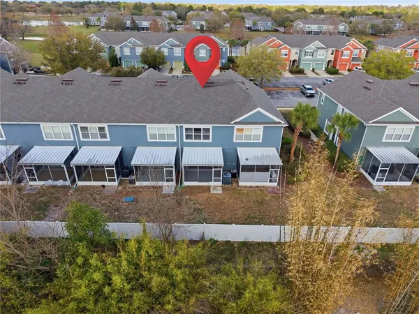 an aerial view of a house with a yard