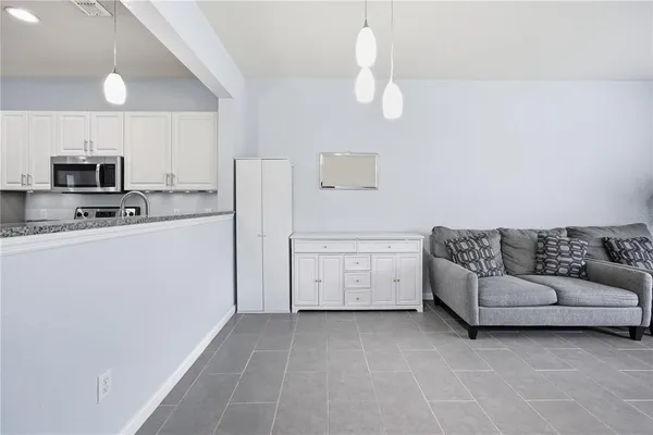 a utility room with cabinets washer and dryer