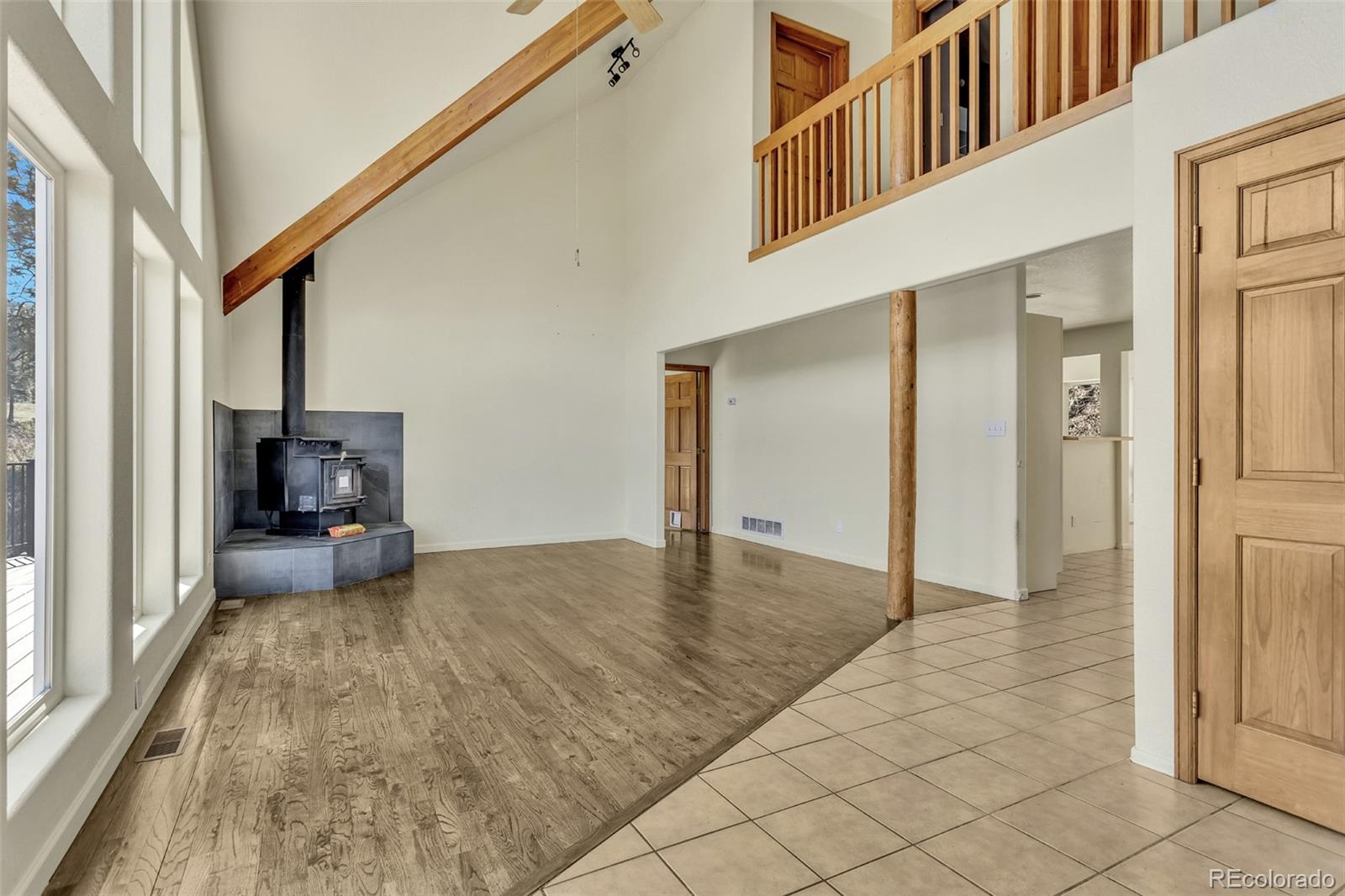 12183 Arnett Ranch Road Littleton, CO 80127 - Photo 2 of 28 a view of a livingroom with wooden floor and furniture