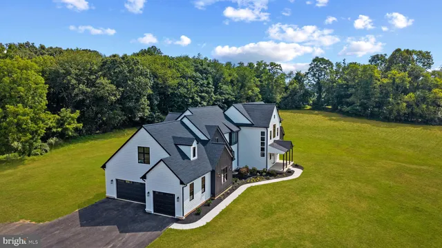 a large kitchen with a lot of counter space and a wooden floor