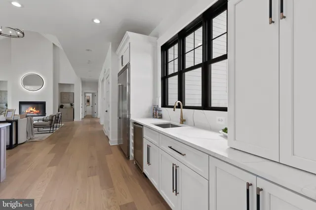 a bathroom with a double vanity sink a mirror and a shower