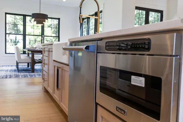 a kitchen with wooden cabinets and refrigerator