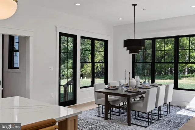a living room with furniture a large window and a flat screen tv