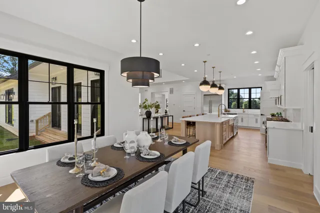 a living room with fireplace furniture and a large window