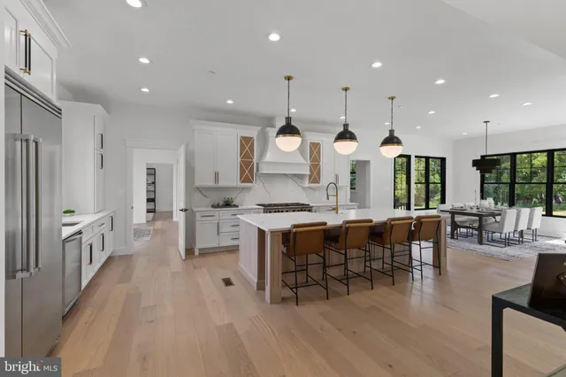 a view of a livingroom with a fireplace cabinet and windows