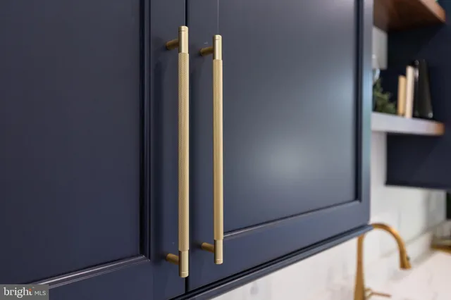 a view of a dining room and livingroom with furniture wooden floor a chandelier