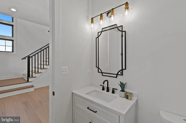 a bathroom with a tub sink and mirror