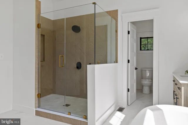 a room with a chandelier and wooden floor