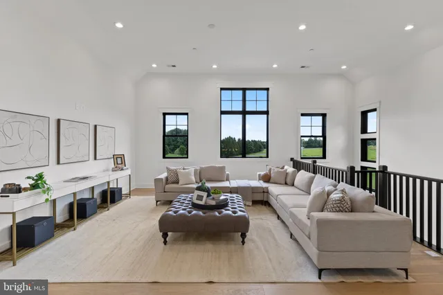 a bedroom with a bed wooden floor and window