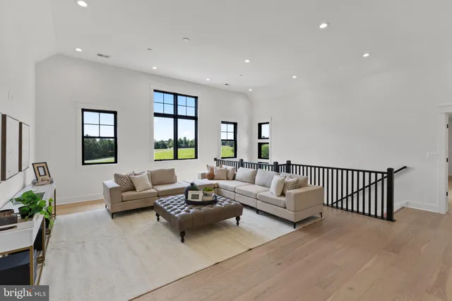 a bathroom with a granite countertop sink mirror vanity and toilet