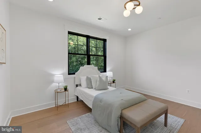 a front view of house with yard and trees in the background