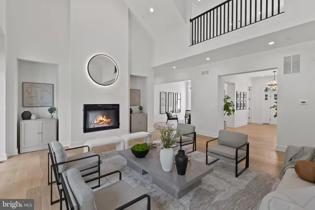 a living room with furniture a rug and a fireplace
