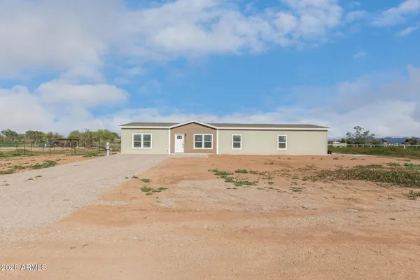 a view of house with yard and ocean