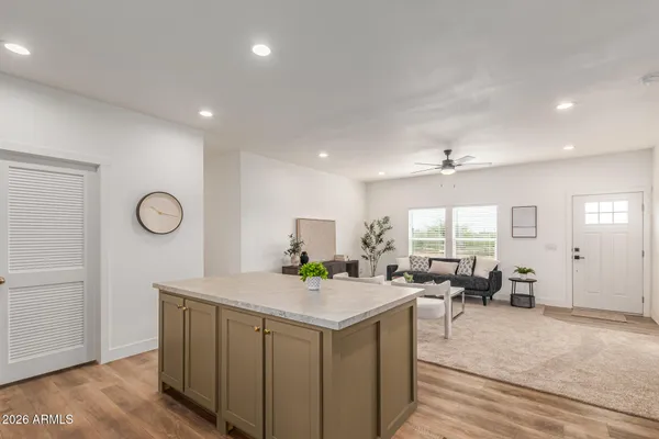 a kitchen with a table chairs refrigerator and couch