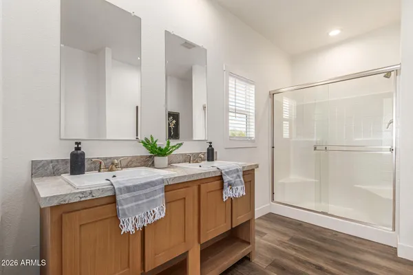a bathroom with double vanity sink and mirror