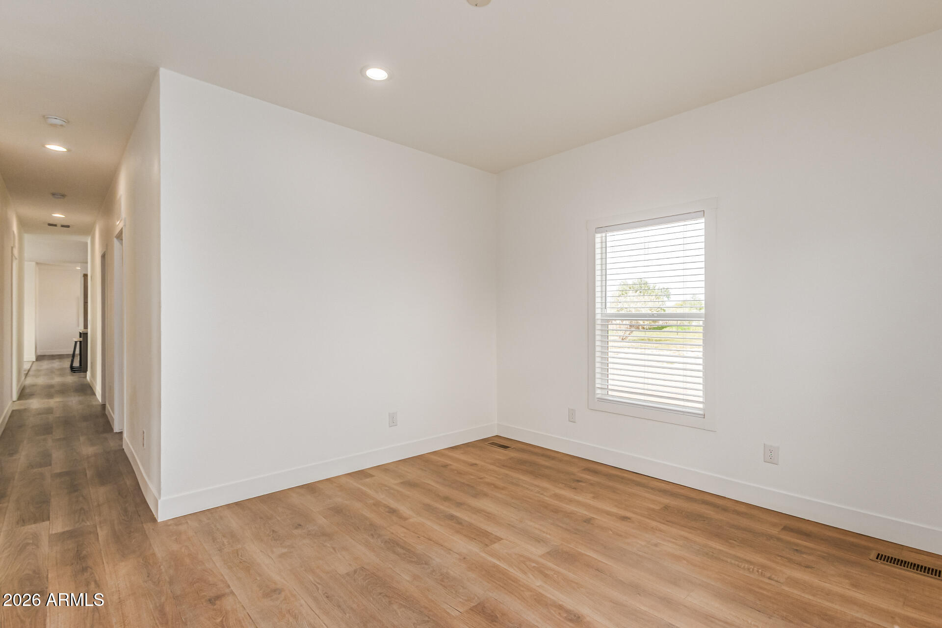 10350 East Shallow Canyon Road San Tan Valley, AZ 85143 - Photo 20 of 40 an empty room with wooden floor and windows