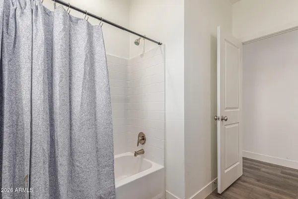 a bathroom with a shower and a tub