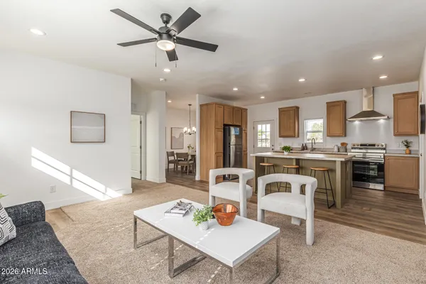 a living room with furniture kitchen view and a potted plant