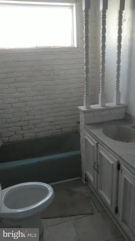 a bathroom with a toilet and a bathtub