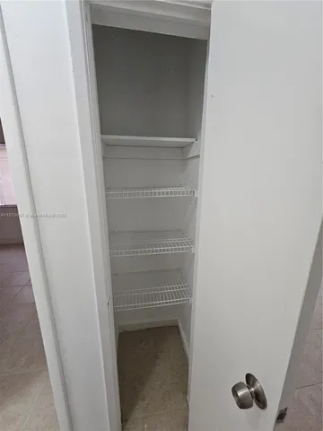 a front view of a house with garage and plants