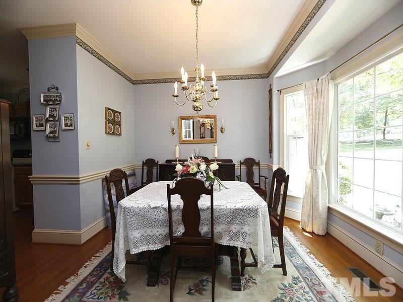 4812 Oak Way Raleigh, NC 27613 - Photo 3 of 18 Hardwoods, crown molding and bay window in this dining room.