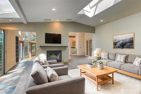 a living room with furniture a flat screen tv and a fireplace