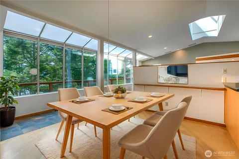 a view of a dining room with furniture window and wooden floor