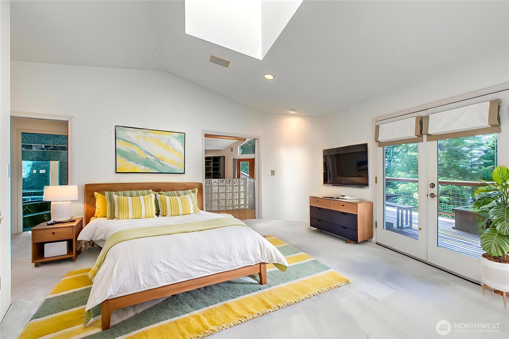 121 Switchback Road Orcas Island, WA 98245 - Photo 20 of 35 a spacious bedroom with a bed and a flat screen tv