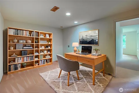 a workspace with furniture window and wooden floor