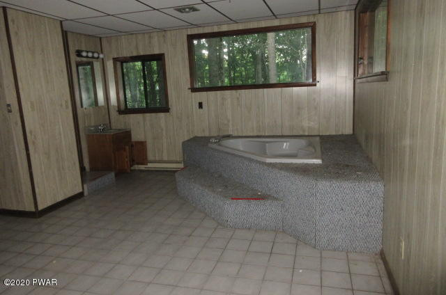 117 Kiel Road Milford, PA 18337 - Photo 9 of 25 a bath tub sitting in a bathroom next to a window