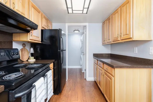 a kitchen with stainless steel appliances granite countertop a stove and a refrigerator