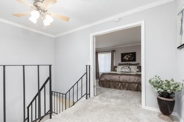 a view of a hallway to a livingroom with furniture