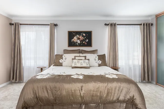 a bedroom with a large bed and a window