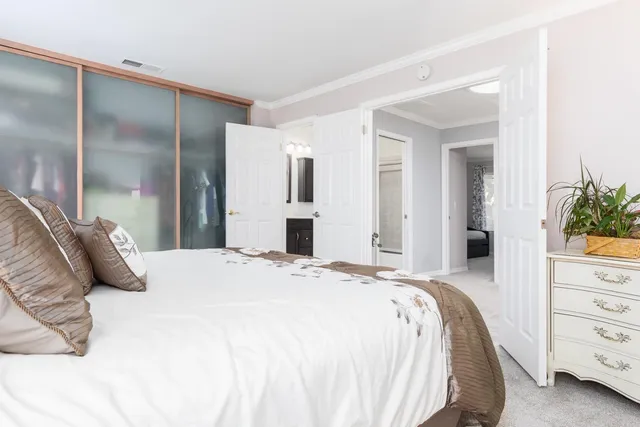 a bedroom with a bed and a mirror