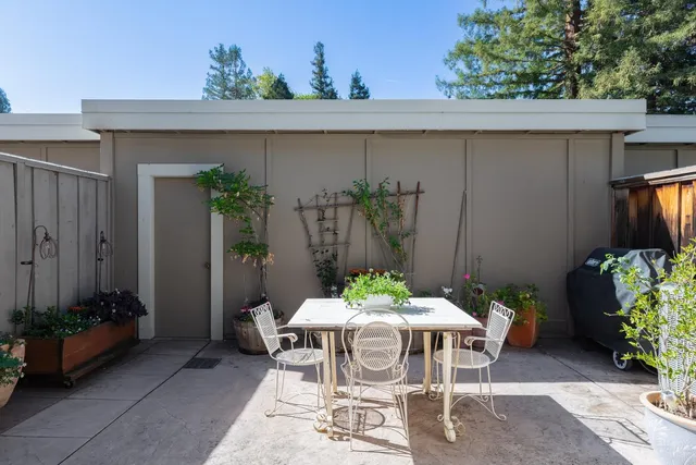 a outdoor dining space with furniture and potted plants