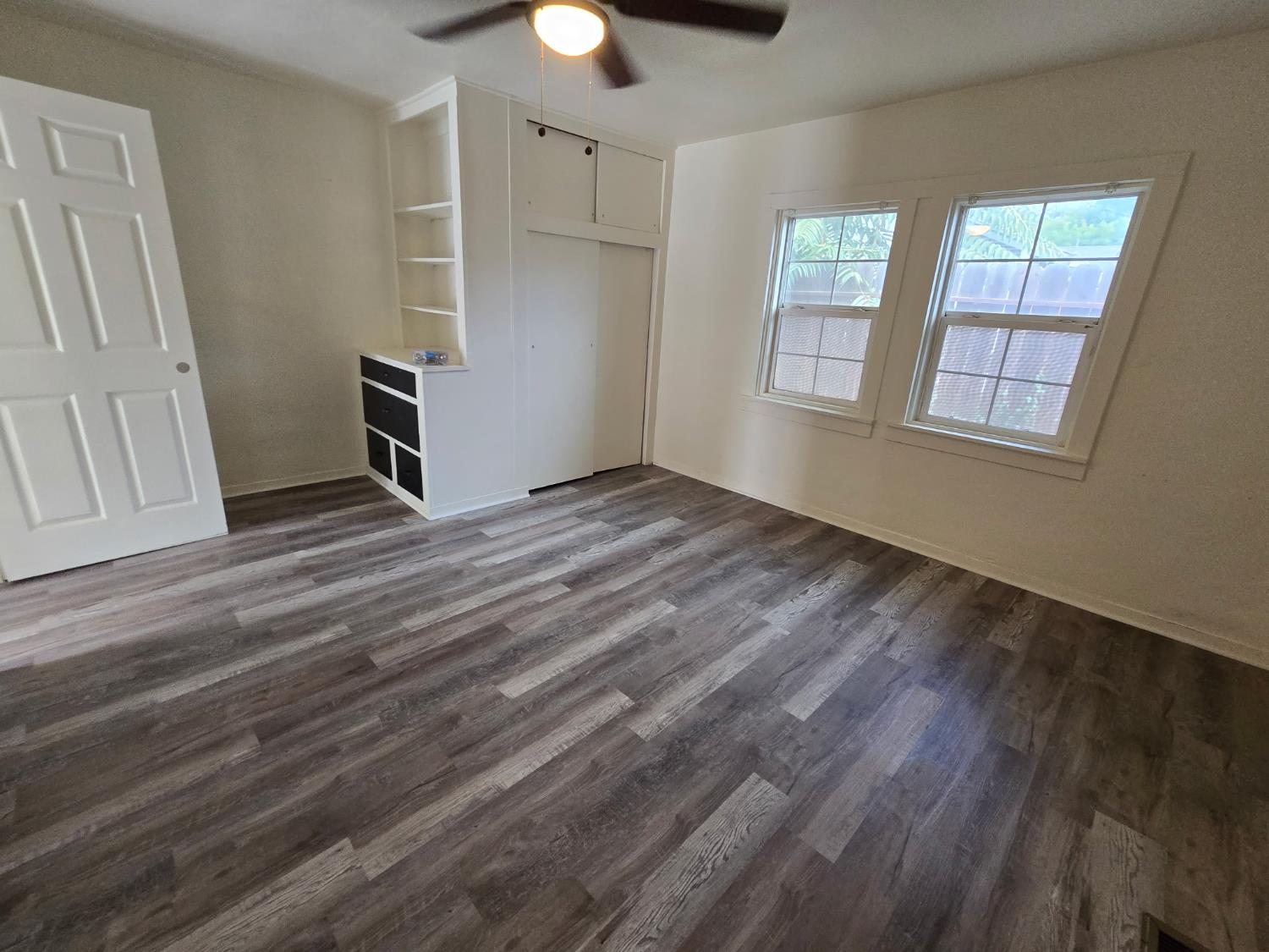 334 Semple Street Modesto, CA 95354 - Photo 11 of 28 a view of an empty room with a window and wooden floor