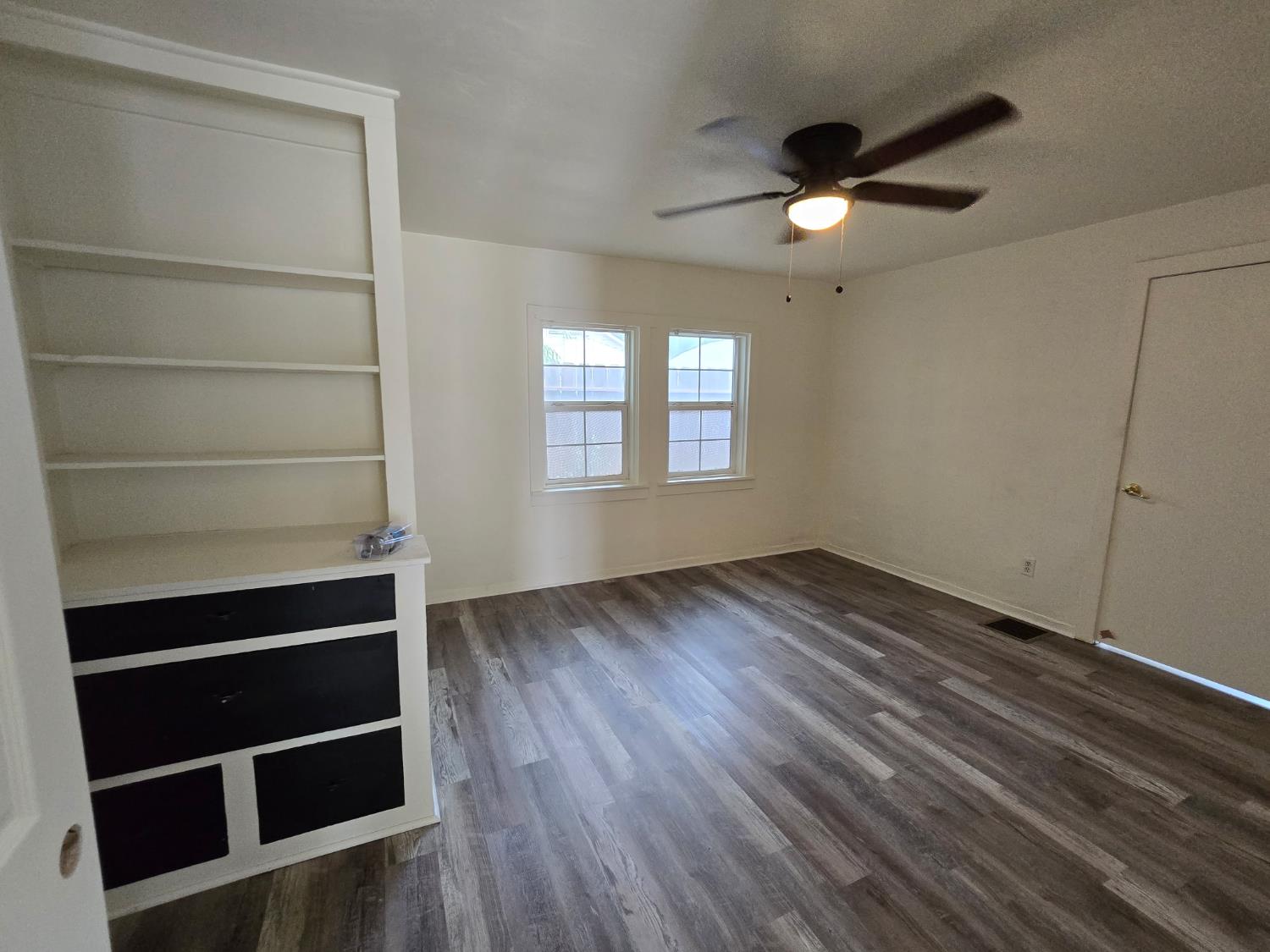 334 Semple Street Modesto, CA 95354 - Photo 12 of 28 a view of an empty room with a window and wooden floor
