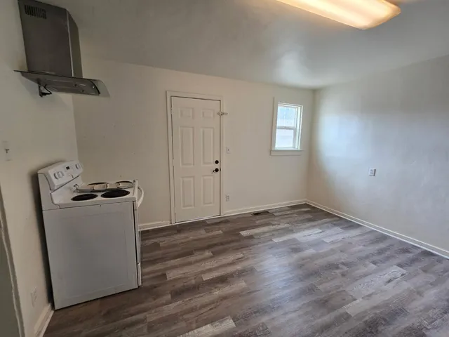 a view of storage and utility room with wooden floor