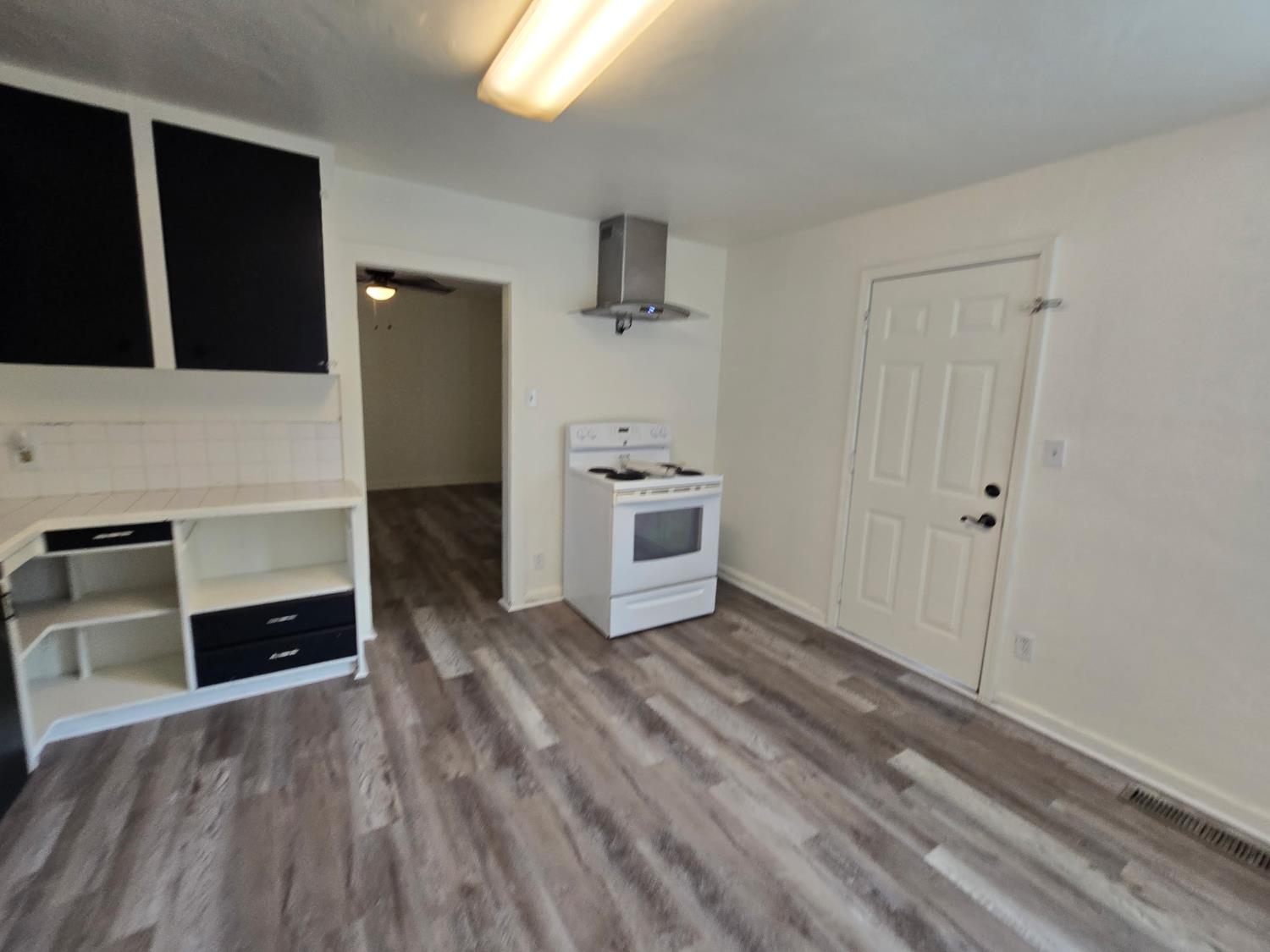 334 Semple Street Modesto, CA 95354 - Photo 23 of 28 a view of a kitchen with wooden floor and electronic appliances