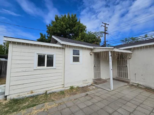 a front view of a house with plants