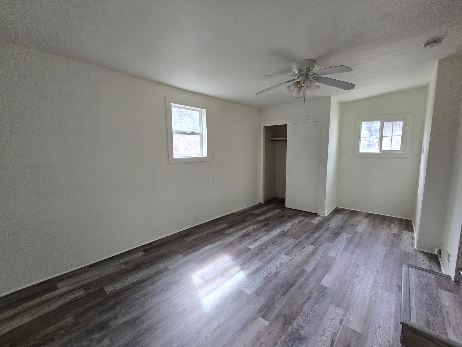 334 Semple Street Modesto, CA 95354 - Photo 10 of 28 wooden floor in an empty room with a window