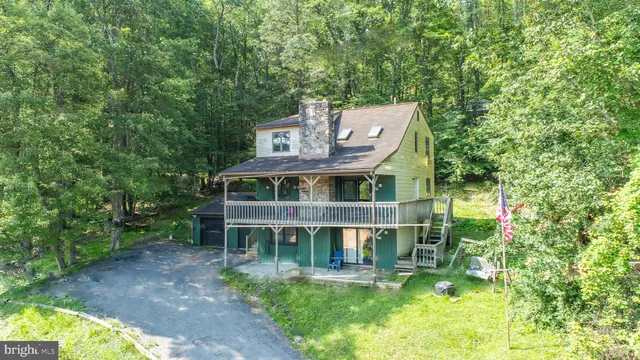 a front view of a house with a yard table and chairs