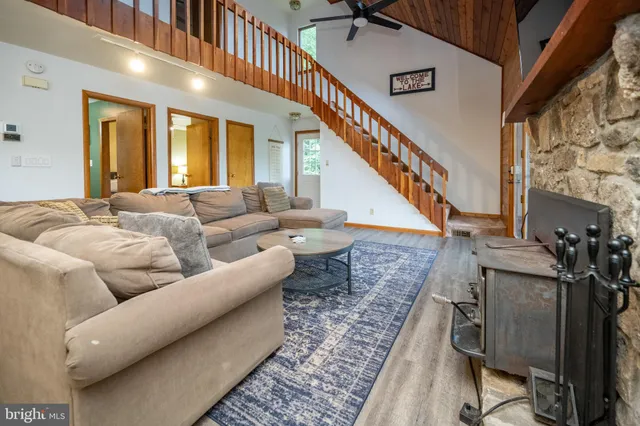 a living room with furniture a flat screen tv and a fireplace
