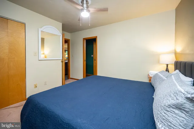 a bedroom with a bed and a lamp