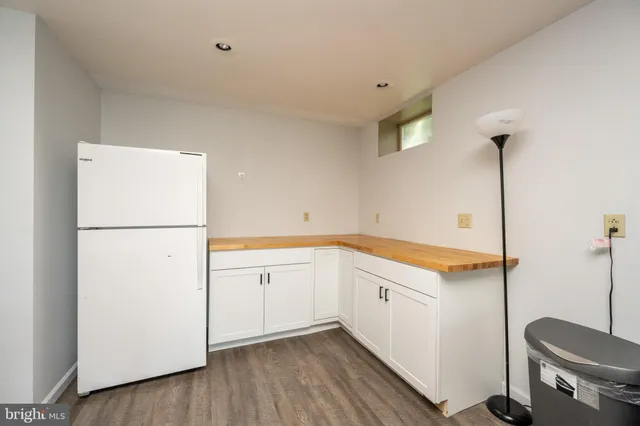 a living room with furniture a ceiling fan and a rug