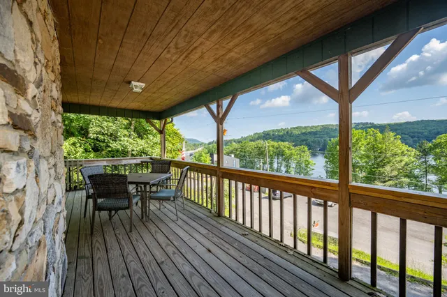 a view of a porch with furniture and wooden deck
