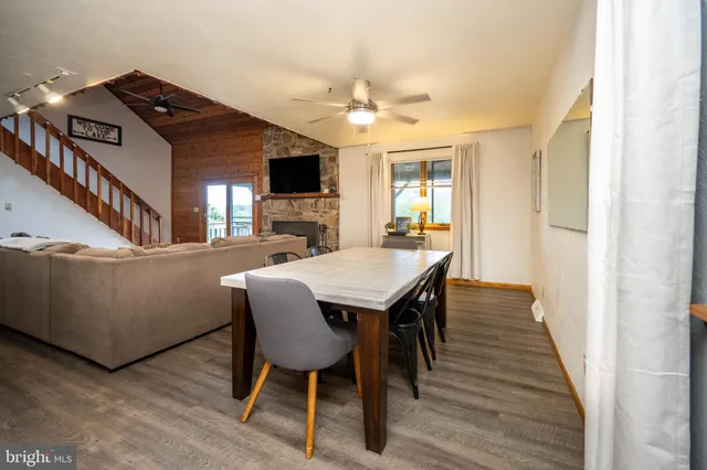 a view of a dining room with furniture and wooden floor