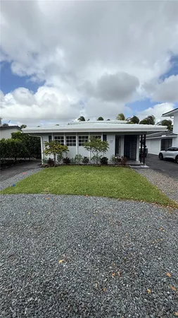 a view of a house with a yard and sitting area